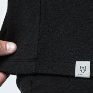 Image of the hem of a shirt showcasing the Woolf Merino logo