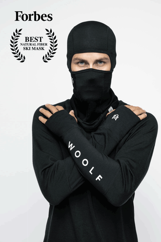 Image of a man against a white background wearing the Svarthetta Balaclava and Svarthetta LS Performance Base Layer Shirt with the Forbes magazine logo and text saying "Best Natural Fiber Ski Mask"